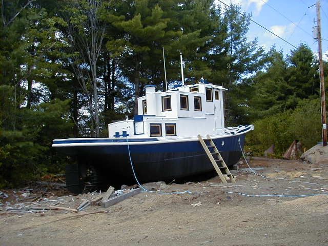 A blue-hulled tug out of the water (undated)