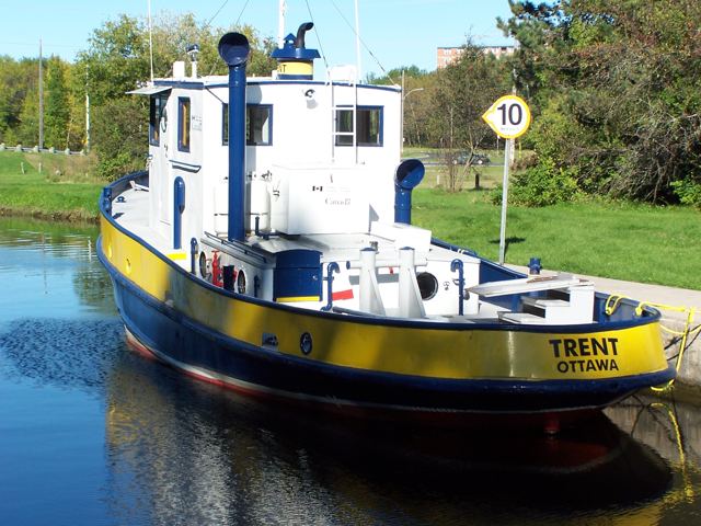 A yellow-and-blue tug lettered “Trent, Ottawa”