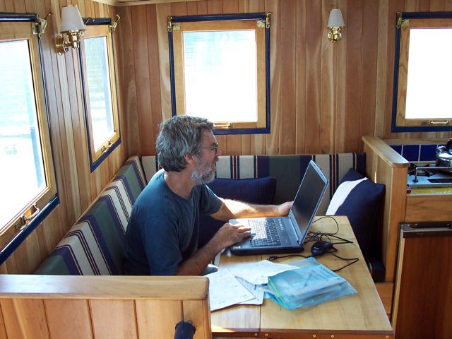 Jim at work on the laptop in the main cabin