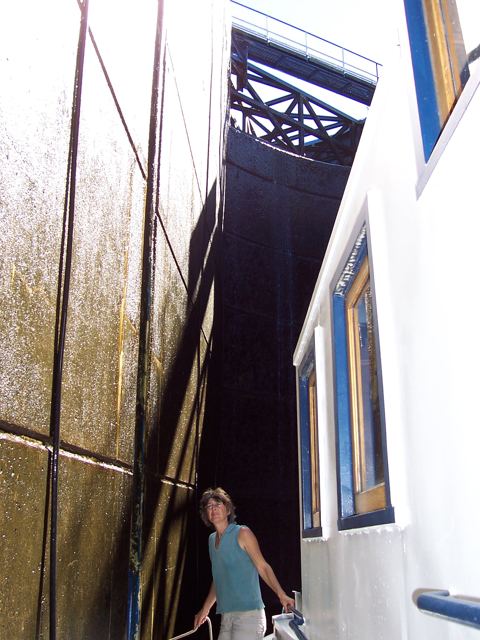 Standing beside the hull inside a lock chamber