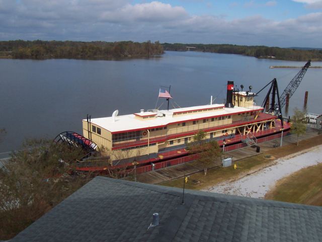 A paddlewheeler tied up on the river bank