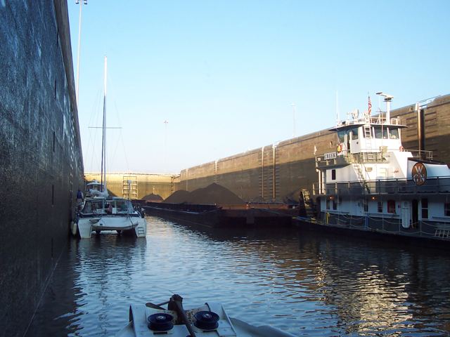 Locking through beside a barge tow