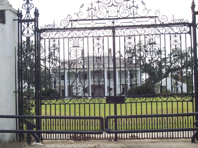 The wrought-iron gates of a plantation house