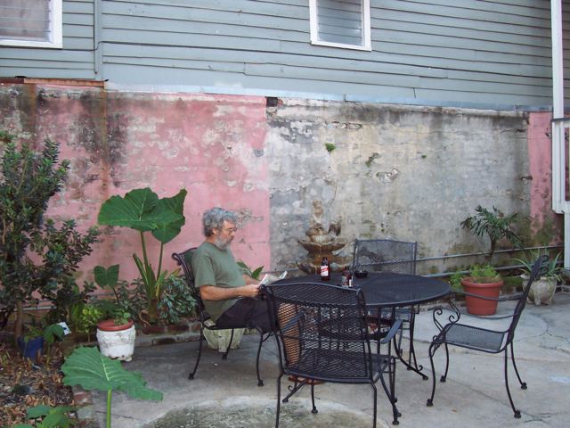 Jim reading in a courtyard