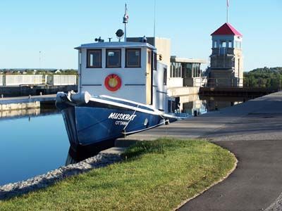 A tug at a lock, the control tower behind