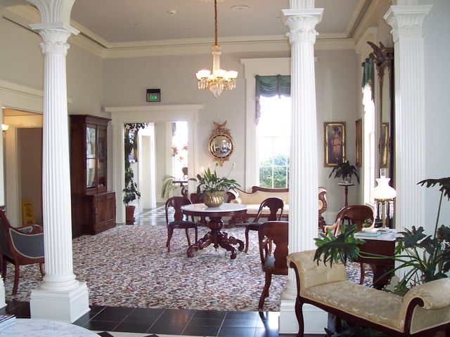The entrance hall of a columned mansion